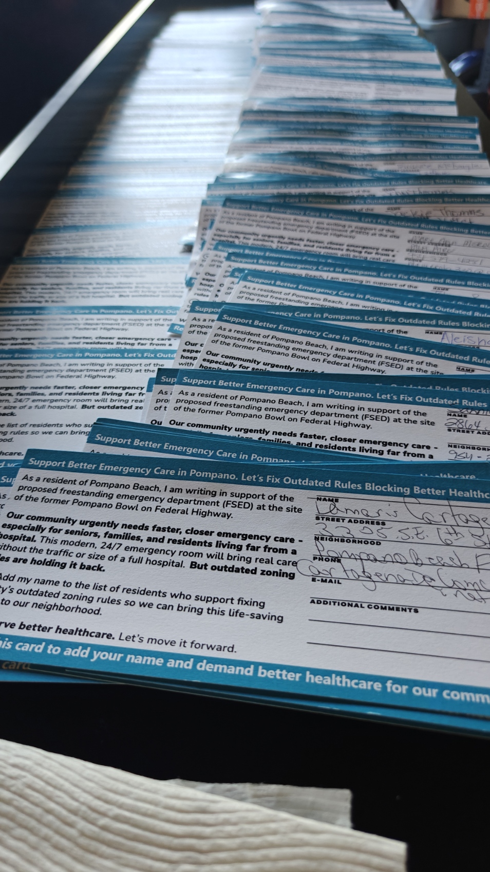 Long line of petition cards showing community engagement